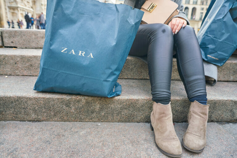 Woman with a Zara branded shopping bag.
